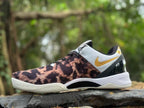 Side view showing the patterned upper, white heel panel, and gold Swoosh on a Nike Kobe 8