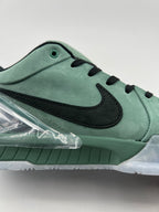 Side detail showing the black Swoosh, green upper and clear heel accent