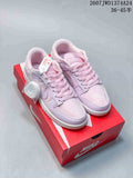 Pink and lilac Nike SB Dunk Low Pro sneakers displayed on a red shoebox, with a spare lace bundle visible.