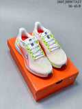 Pair of Nike Quest 6 running shoes in light pink and white with neon green accents, displayed on an orange shoe box.