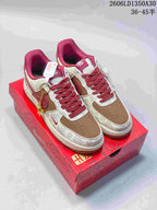 Pair of cream, brown, and burgundy low-top sneakers with patterned panels.