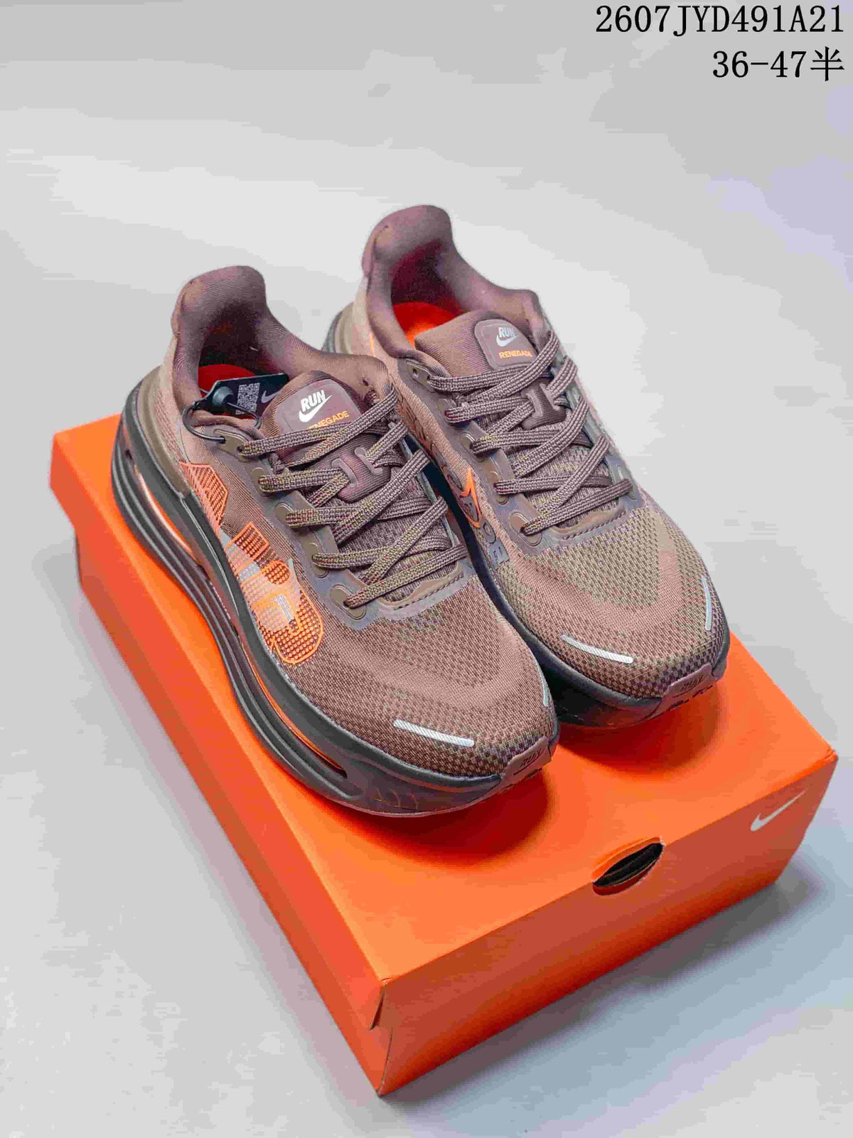Pair of brown Nike Air Pegasus Premium sneakers with orange accents shown on an orange shoe box.