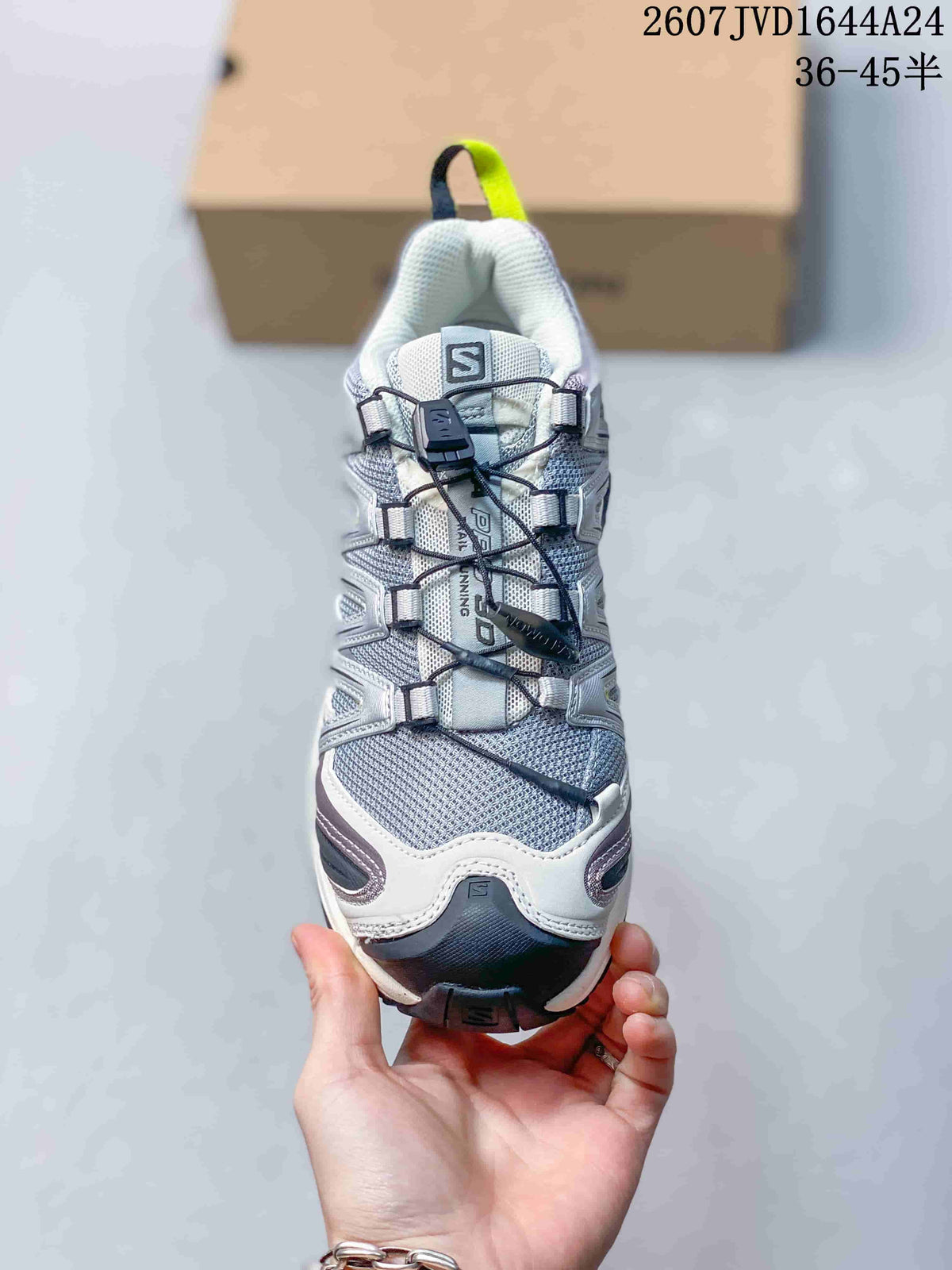 Front view of the Salomon sneaker showing the mesh-look upper, toggle lacing, padded collar and protective toe area.