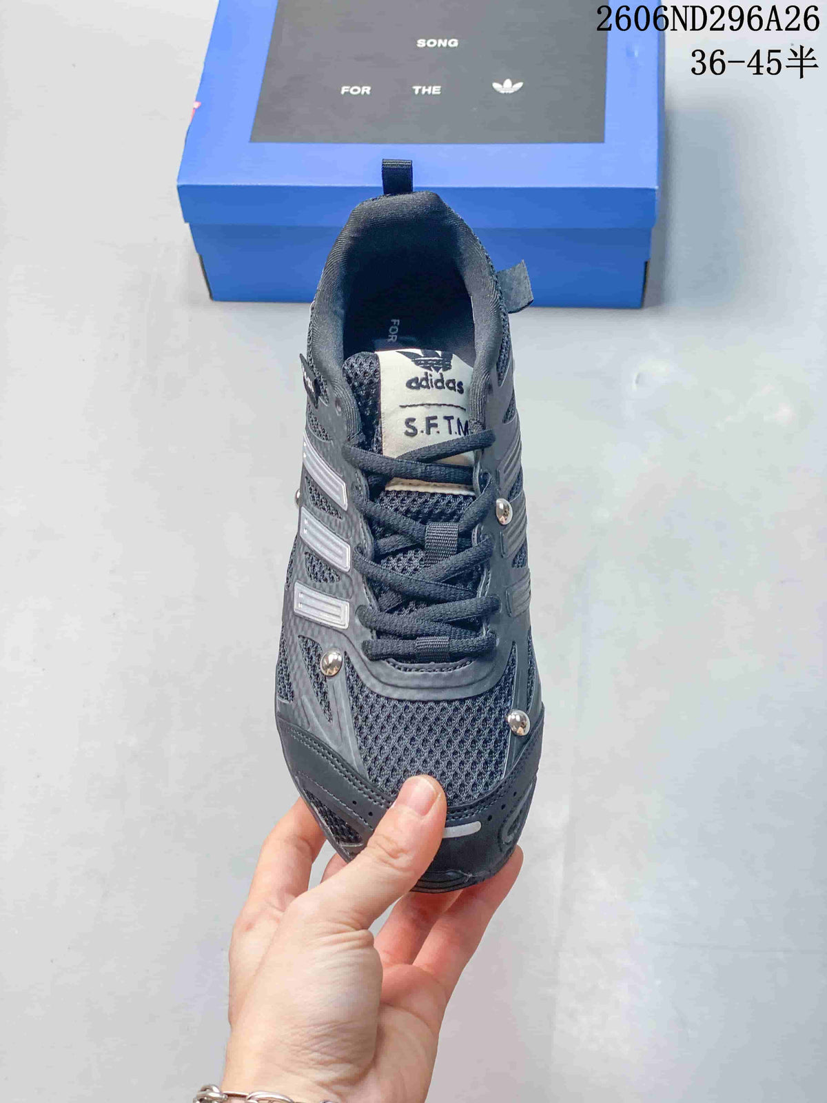 Front view showing the laces, textured upper panels, silver accents, and S.F.T.M. tongue label.