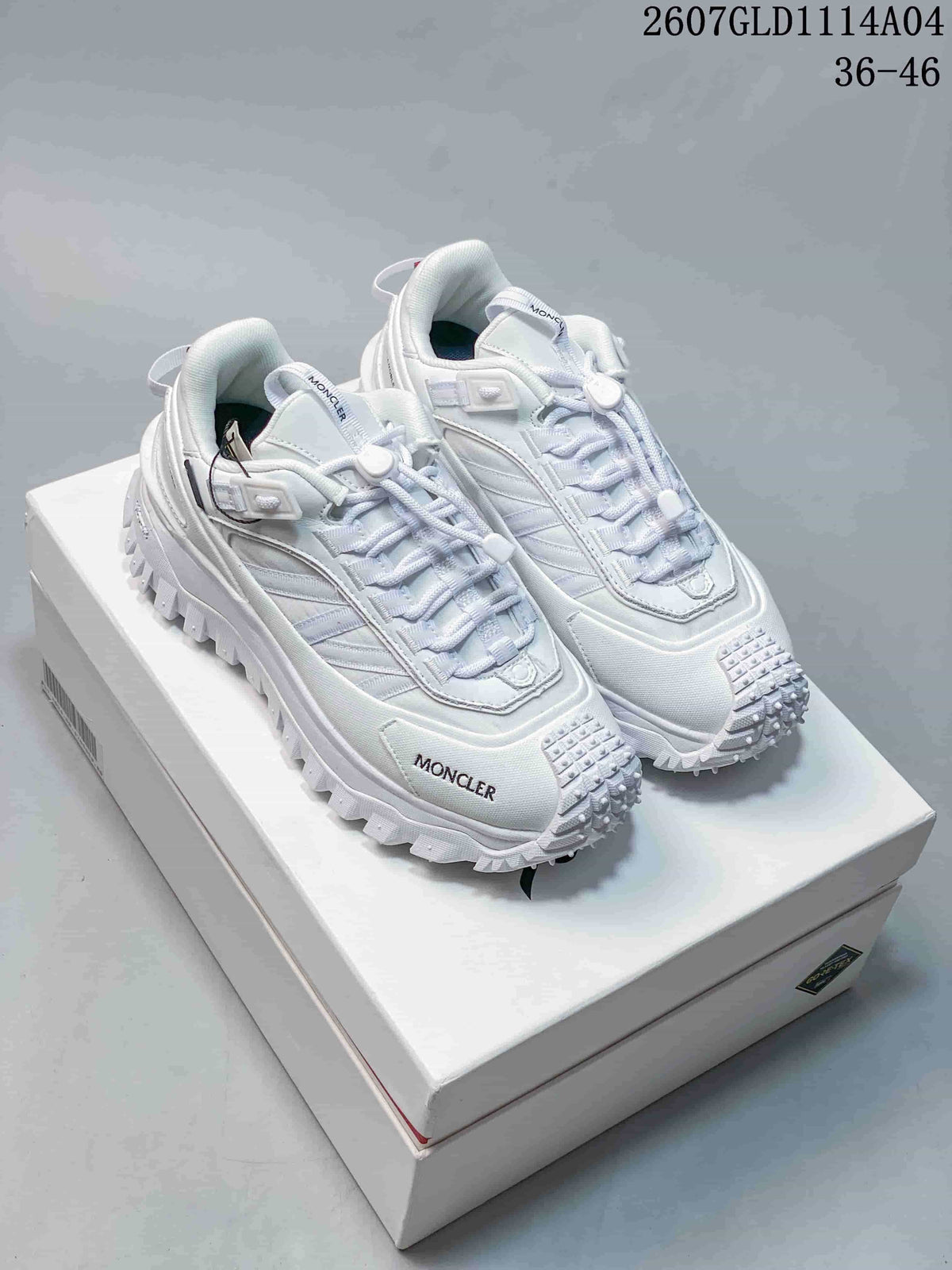 Pair of white Moncler Pacey low-top sneakers displayed on a white shoe box, with size range 36-46 and style code 2607GLD1114A04 visible at the top.