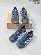Several views of gray lace-up sneakers with light side panels and orange-colored interior accents.