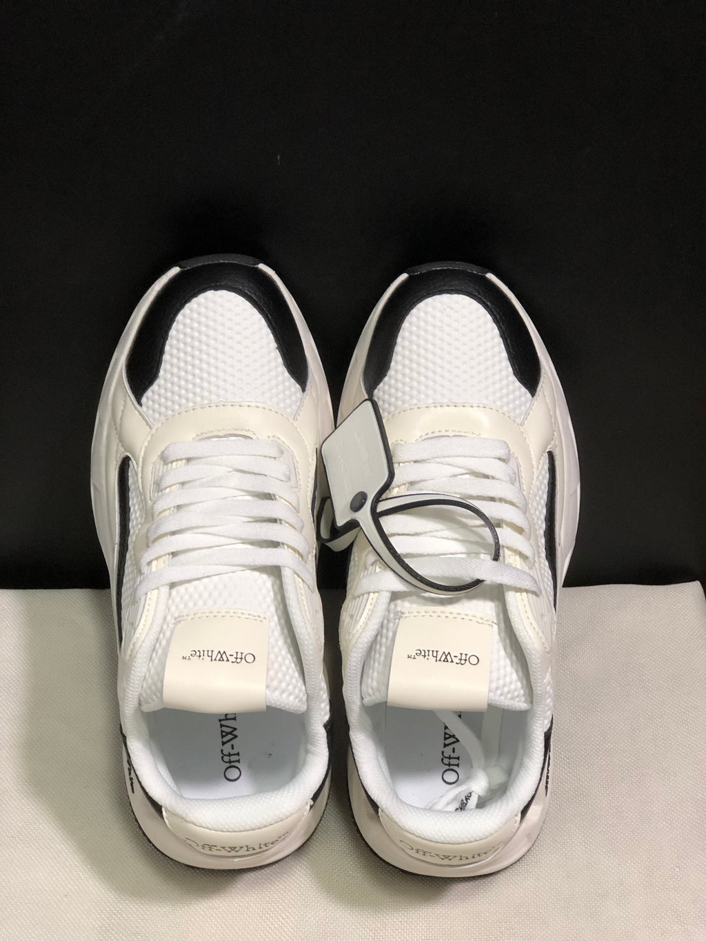Top-down view showing the white laces, padded collars, textured panels, and branded tongues.