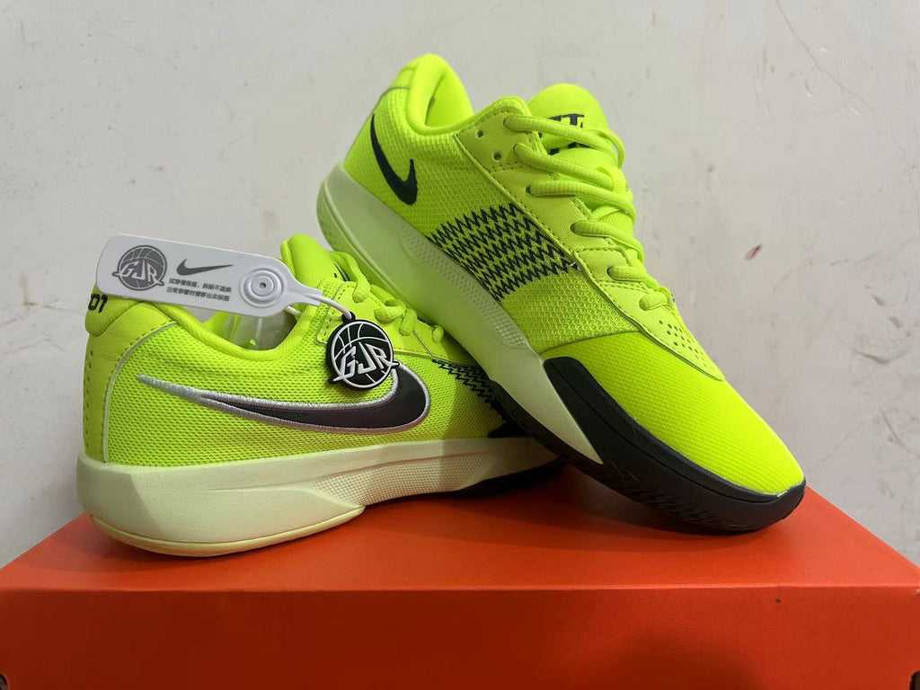 Pair of bright green Nike basketball shoes shown from the side and at an angle