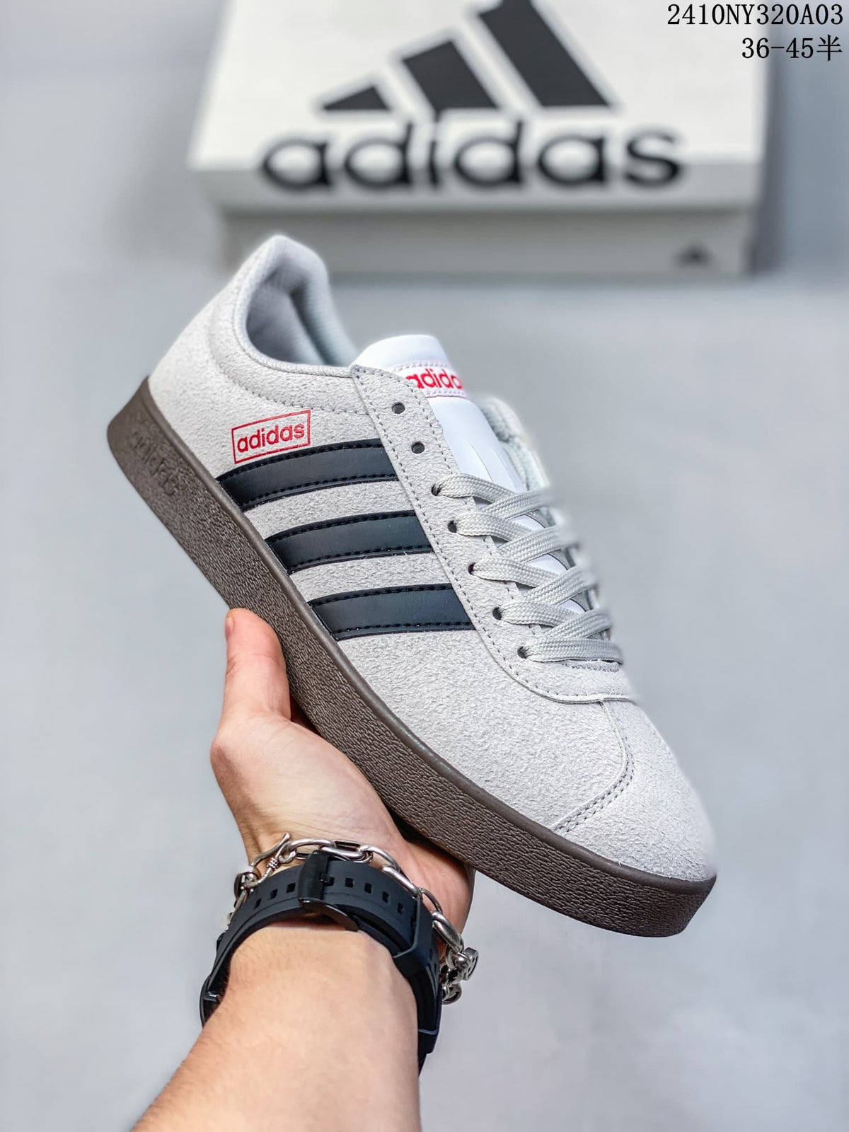 Close side view showing the black three stripes, Adidas side branding, and lace-up construction.