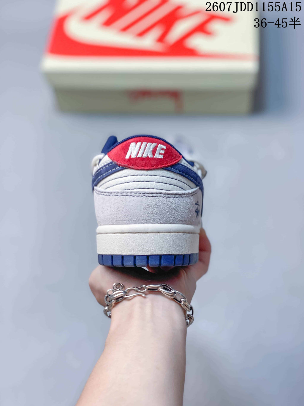 Rear view showing the white heel panel, navy outsole edge and red tongue detail.