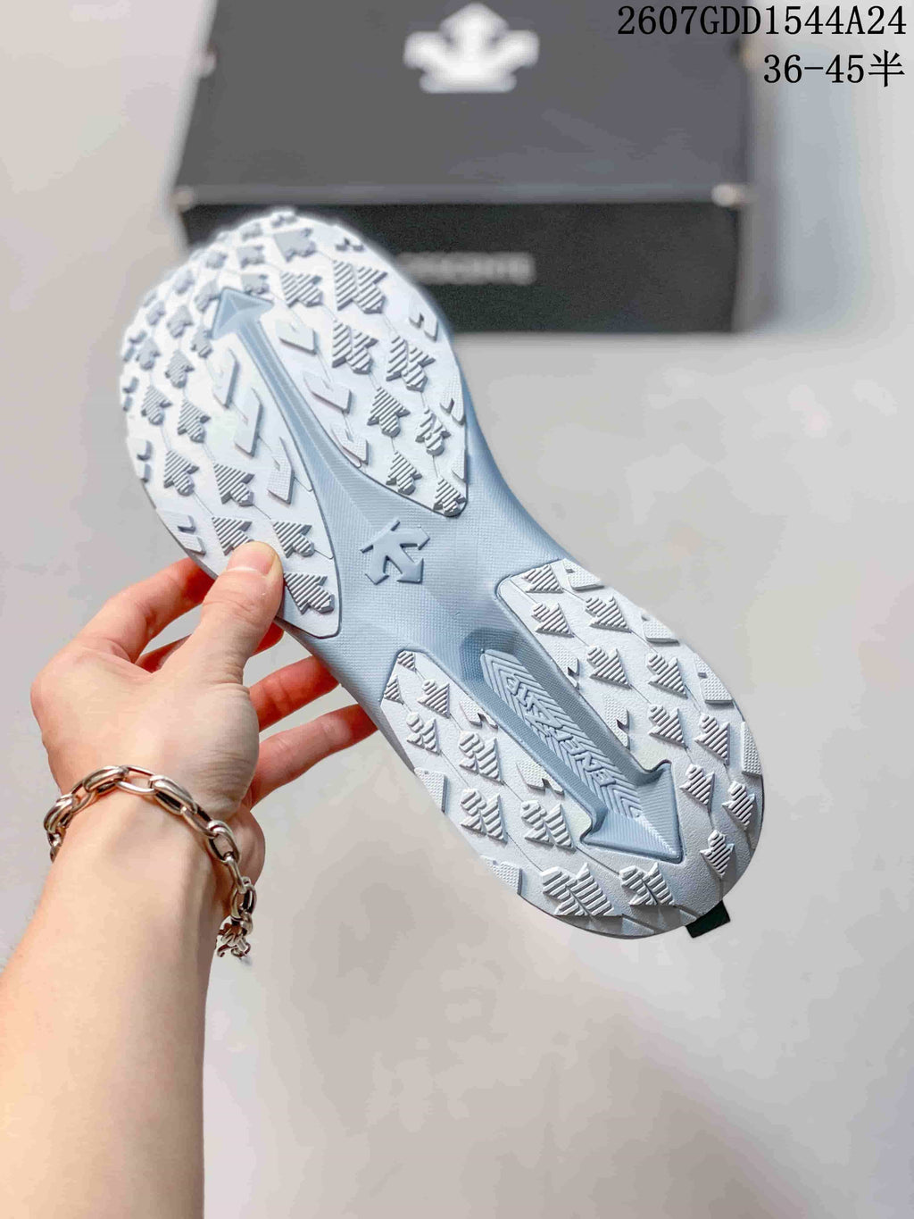 Underside view showing the segmented traction pattern on the light blue and white outsole.