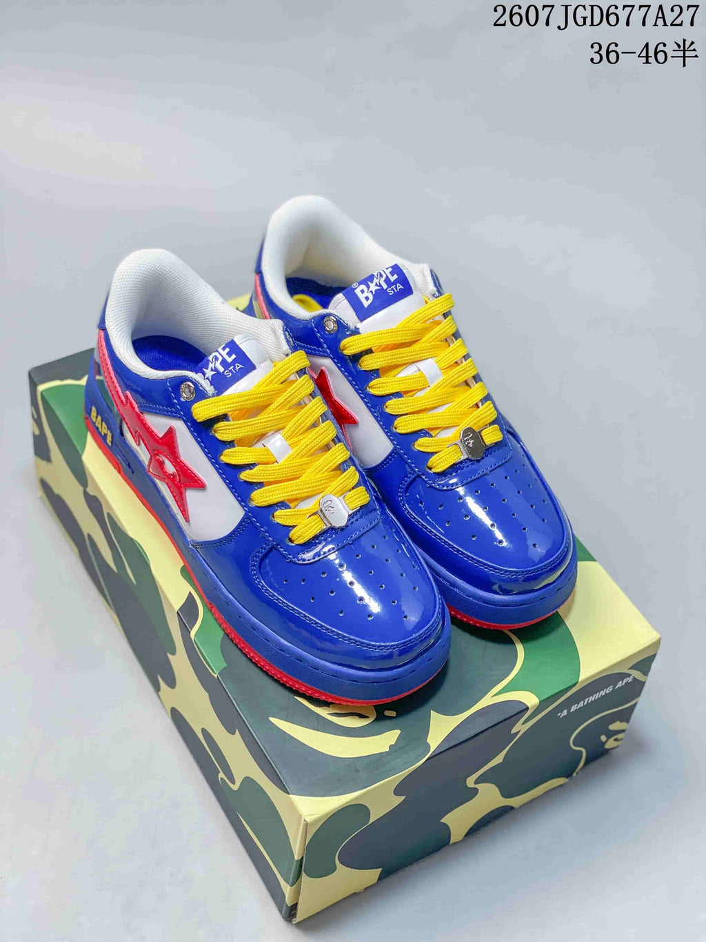 Pair of blue, red, white, and yellow BAPE Star To Low sneakers displayed on a camouflage-patterned box; image text shows style code 2607TGD677A27 and size range 36–46.5.