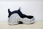 Side profile of a silver and black Nike Foamposite Pro shoe