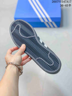 Close view of the sneaker outsole showing a dark rubber sole with a repeating zigzag tread pattern.