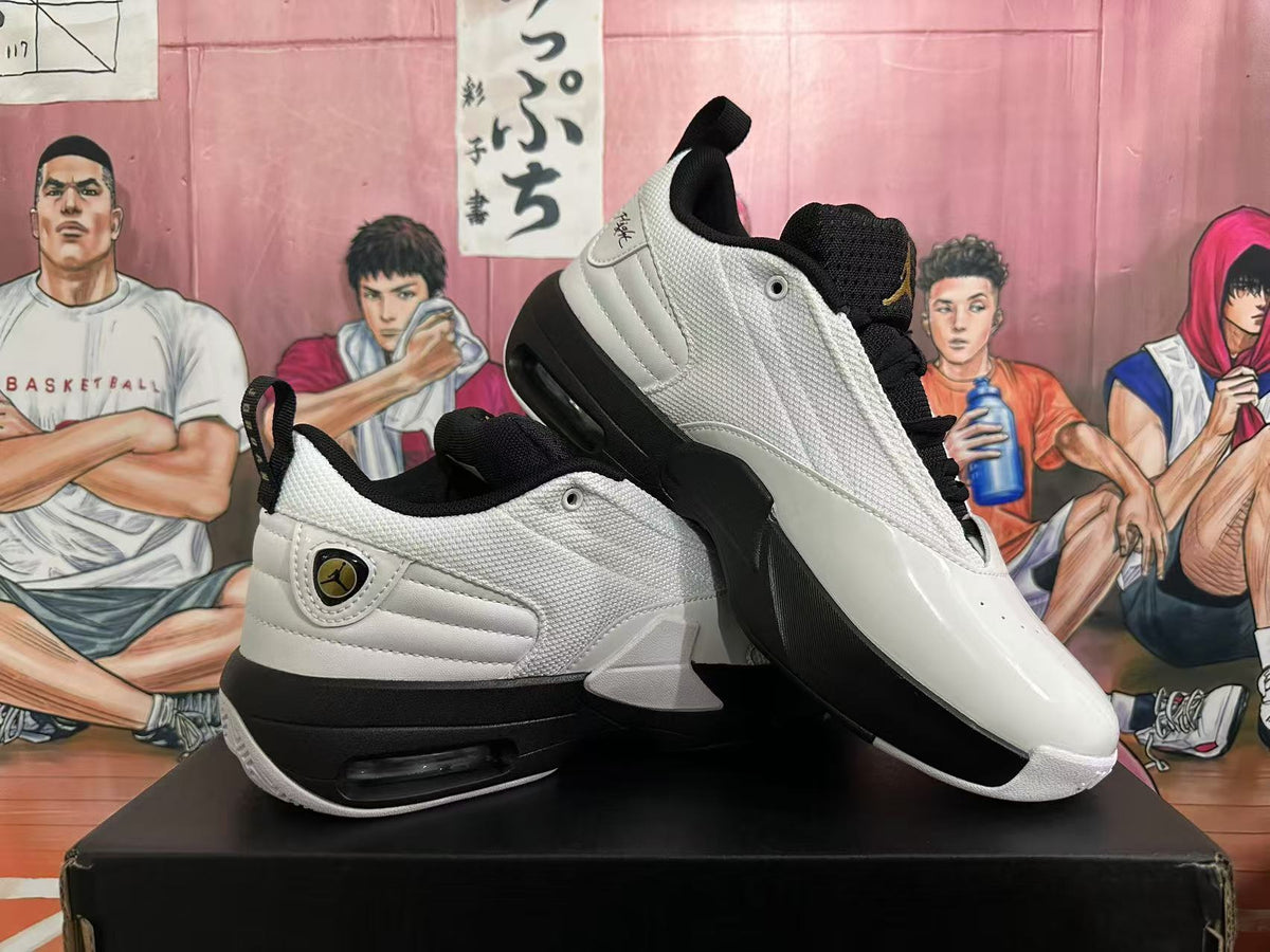 Angled view of a pair of white and black Jordan sneakers displaying the side panels, heel units and outsole.