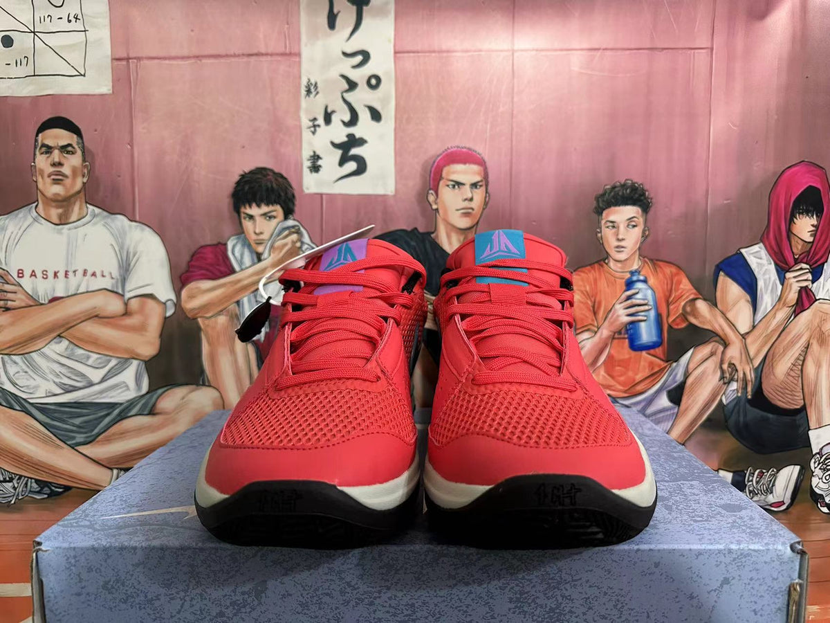 Front view of red Nike basketball shoes with mesh panels, red laces, and colored tongue details.
