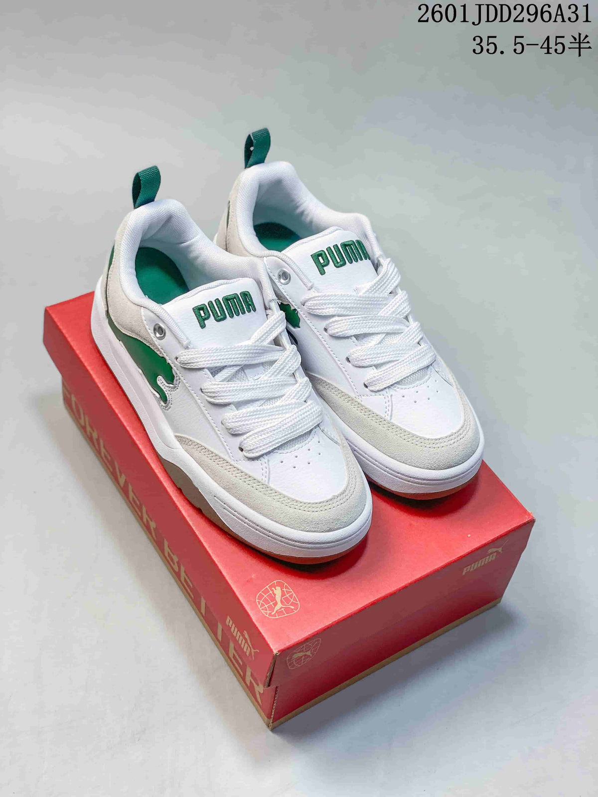 Pair of white PUMA 180 sneakers with green accents and a chunky sole.