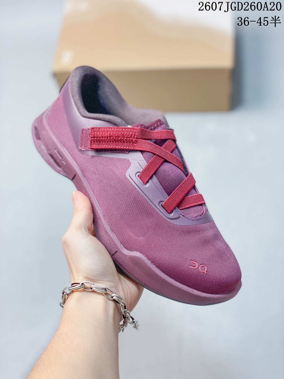 Angled side view of the plum-purple On sneaker showing the textile-looking upper, webbing system, and layered outsole.