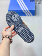 Close view of the textured rubber outsole with circular traction elements and adidas branding.