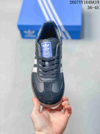Top view of the black lace-up sneaker showing the blue adidas tongue label, black laces and contrasting toe panels.