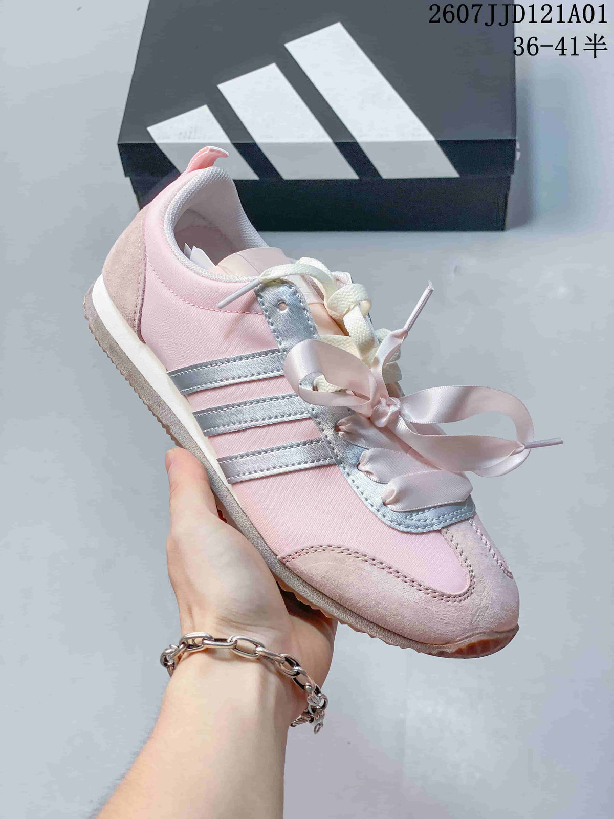 Side view of a pink JOG 2.0 sneaker with silver stripes