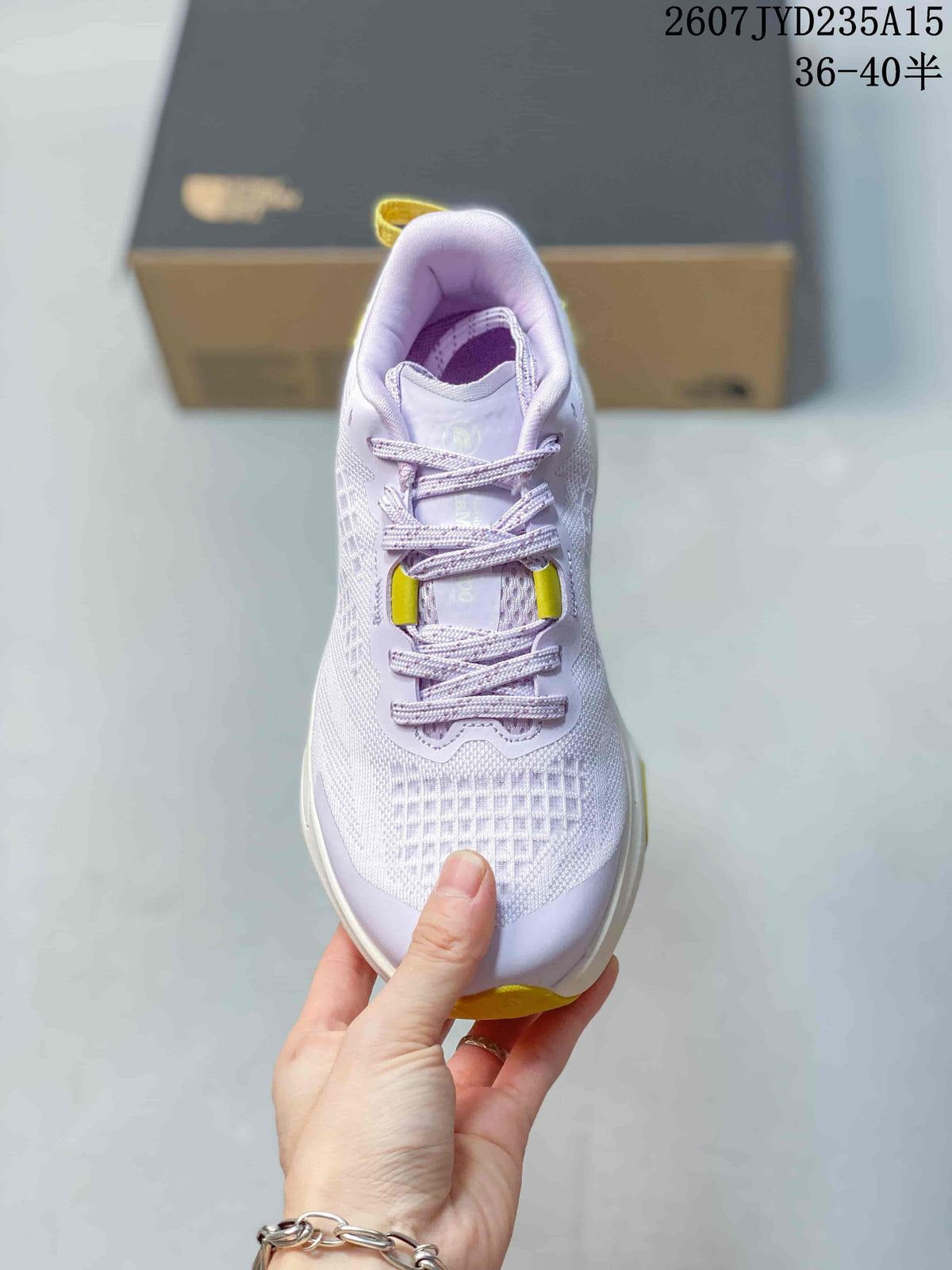 Top view showing the lace-up construction, textured toe area, purple upper, and yellow lace-area accents.