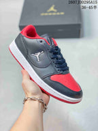 Black and red low-top Jordan sneaker held at an angle, with red lining, red toe panel, and red outsole accents.