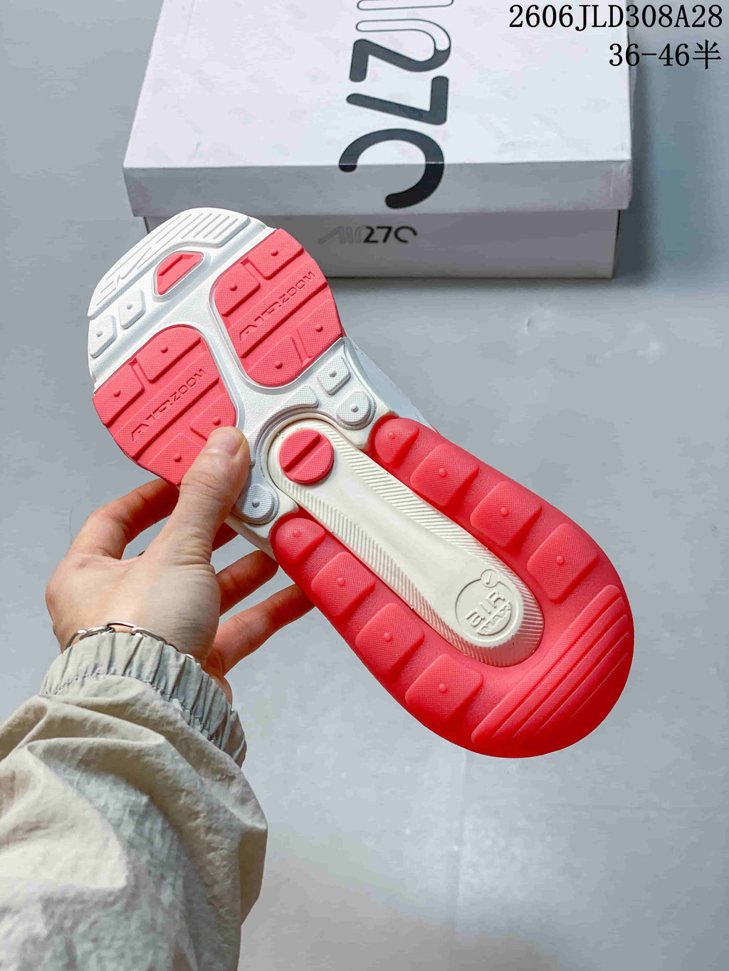 Underside of a Nike Air Max 270 Premium sneaker showing its red and white outsole