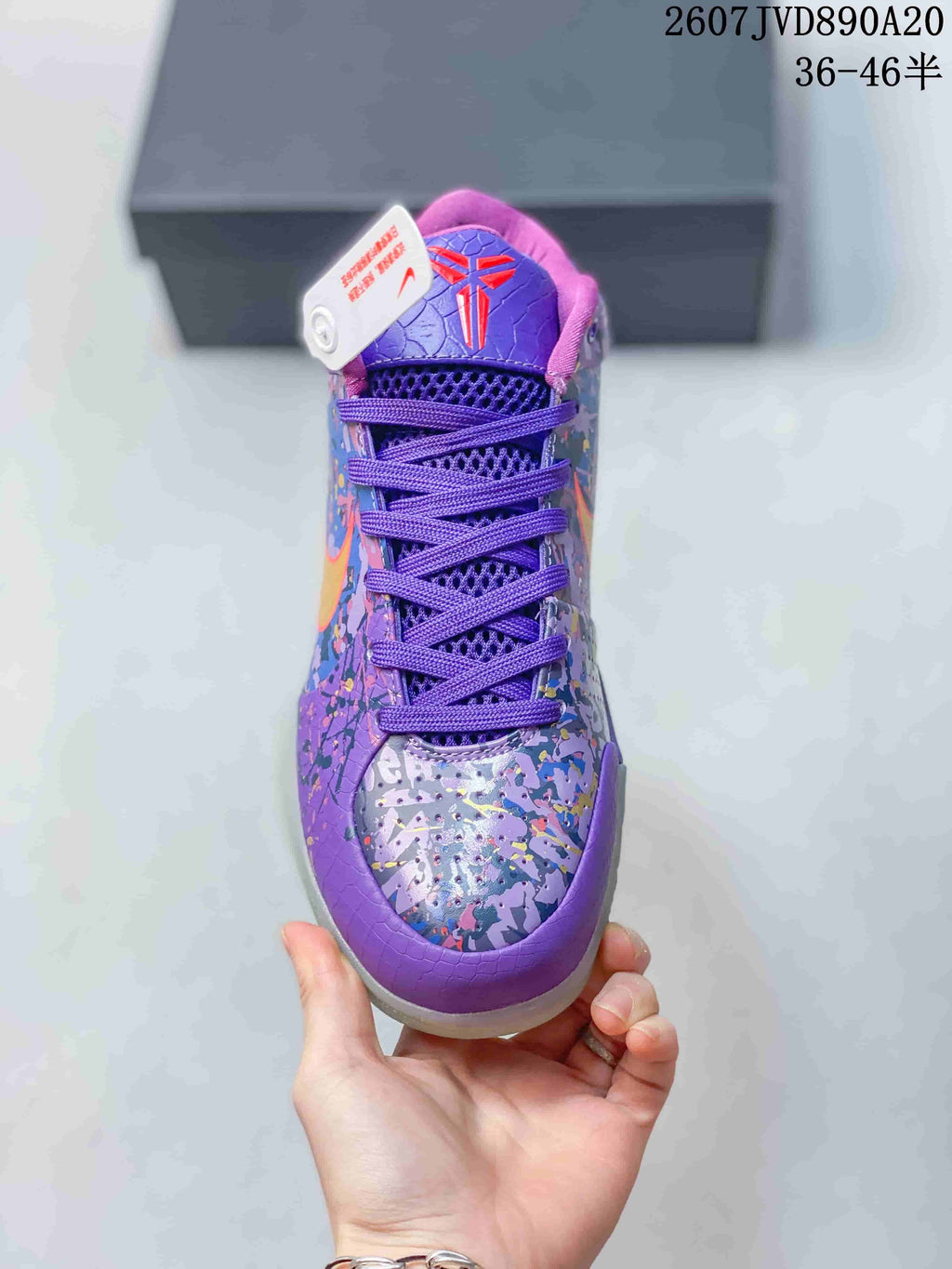 Top view of the purple basketball shoe showing the lacing system, tongue emblem and multicolor toe design.