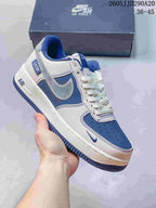 Close-up of a white and blue Nike Air Force 1-style sneaker showing contrast stitching, blue panels and a dark blue outsole.