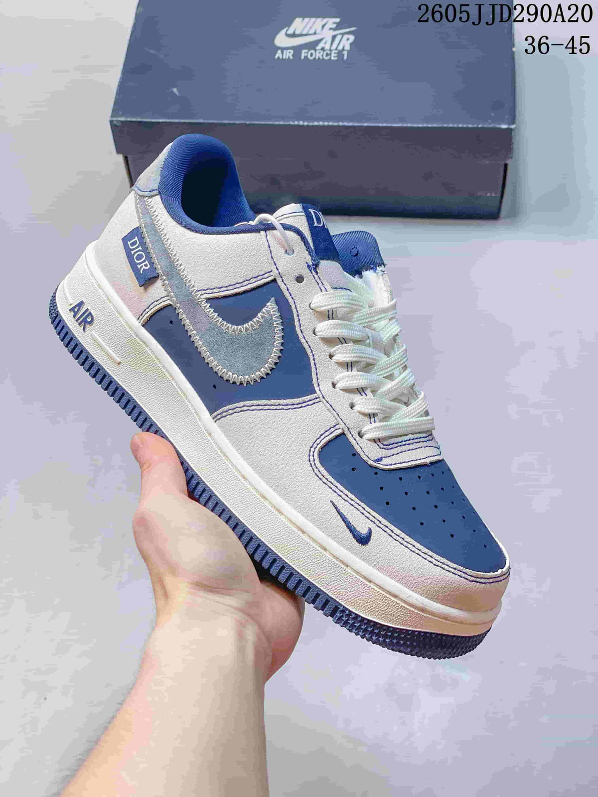 Close-up of a white and blue Nike Air Force 1-style sneaker showing contrast stitching, blue panels and a dark blue outsole.