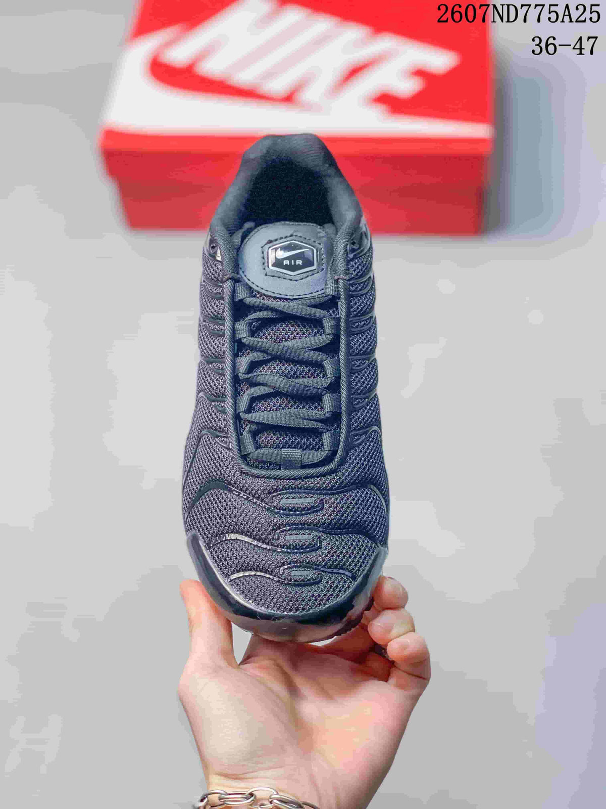 Top view of the black sneaker showing the lace-up construction, textured upper, and Air tongue label.