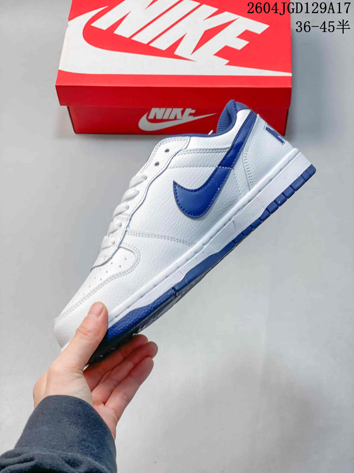 Side view highlighting the blue Swoosh and white upper