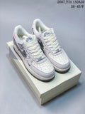 Pair of white and gray Nike Air Force 1 low-top sneakers displayed on a shoebox, showing the patterned Swoosh and perforated toe boxes.