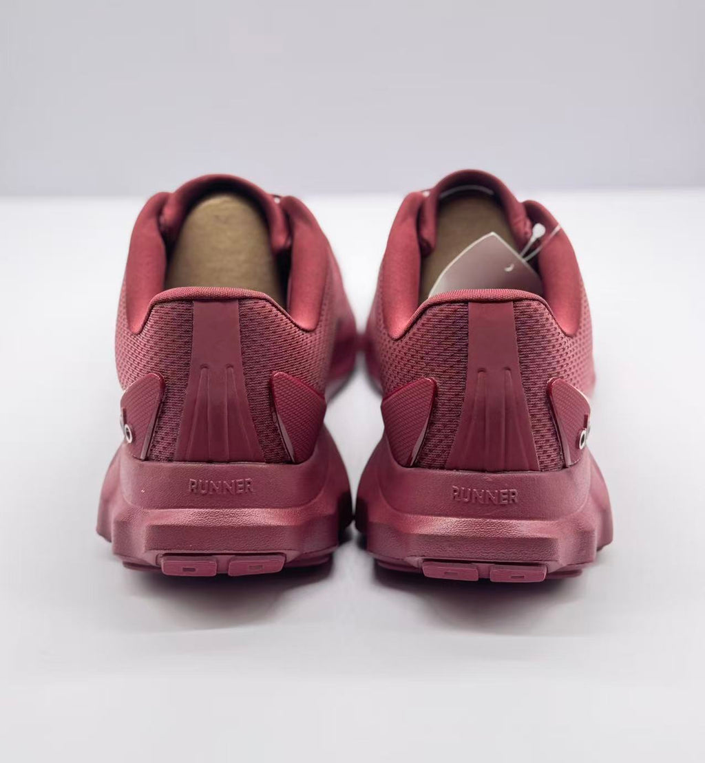 Rear view showing the padded collars, heel structure, outsole, and RUNNER heel detail.