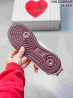 Close view of the burgundy rubber outsole with concentric circular traction patterns.