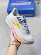 Angled side view of the white Brooks Ghost 17 sneaker with yellow and pink accents.