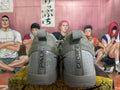 Rear view of grey Nike basketball shoes with patterned heel panels and pull tabs.