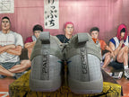 Rear view of grey Nike basketball shoes with patterned heel panels and pull tabs.