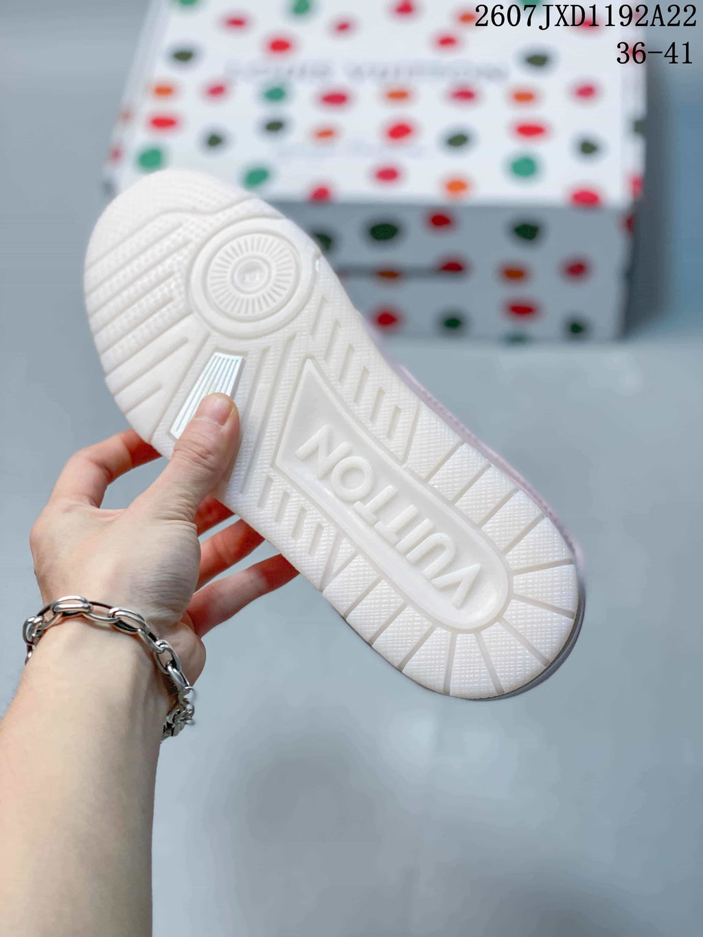 Underside view showing the white textured rubber outsole and raised branding detail.