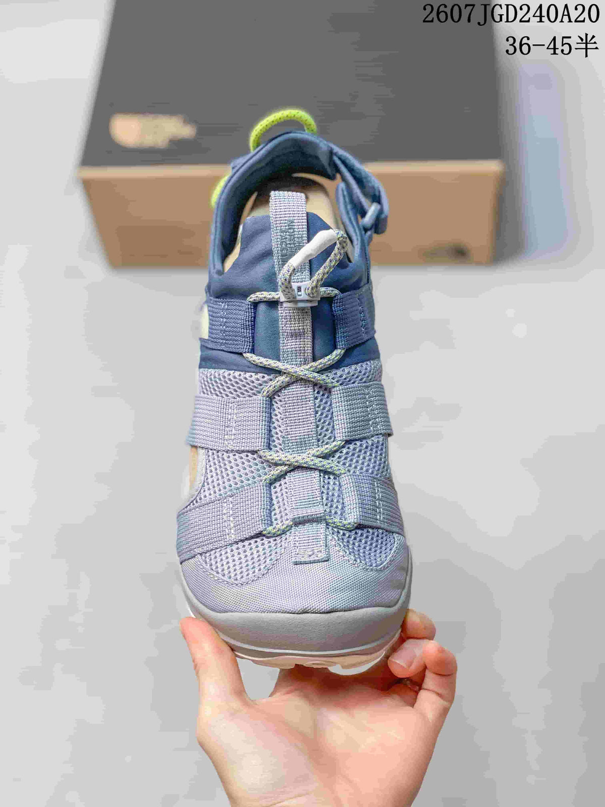 Front view of the sandal showing the open strap construction, mesh upper and toggle-style lacing detail.