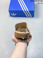 Rear view showing the heel and cork-look midsole edge of an adidas Adimule slipper.
