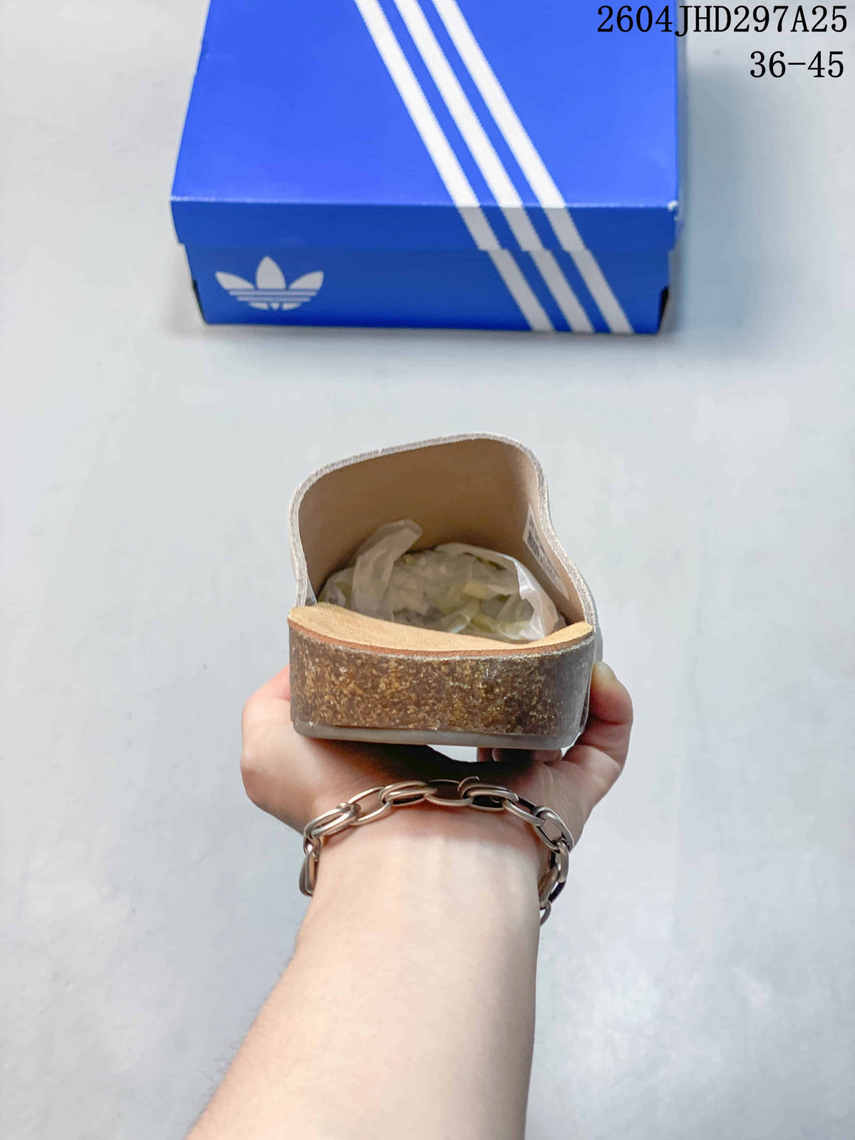 Rear view showing the heel and cork-look midsole edge of an adidas Adimule slipper.