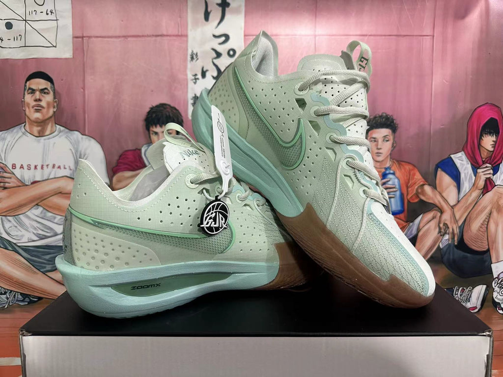 Pair of pale green and white Nike G.T. Jump 2 basketball shoes shown at an angle