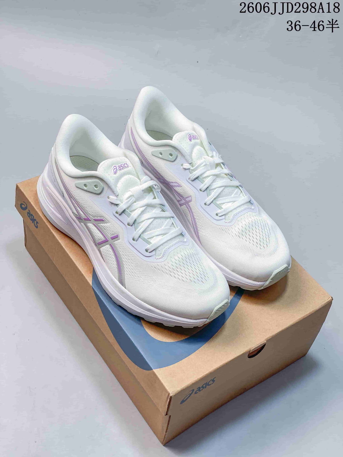 Pair of white and lilac ASICS GT-1000 13 running shoes displayed on an ASICS shoe box.