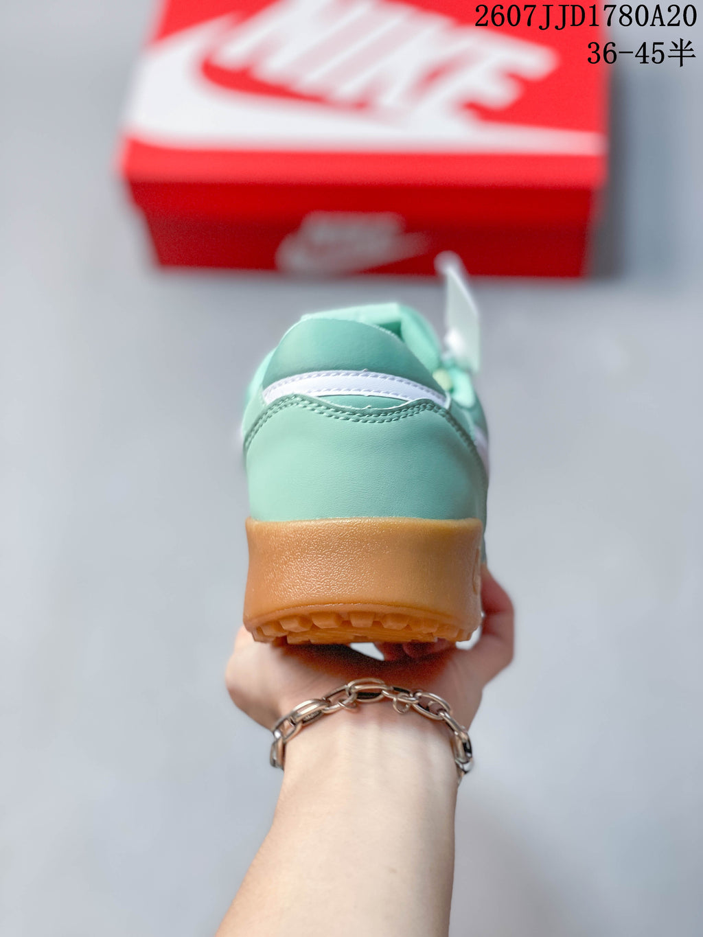 Rear view showing the mint green heel, white detail and gum-colored outsole.