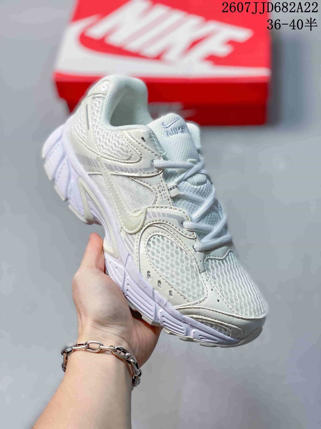 Three-quarter side view of the white Nike V5 RNR sneaker showing the mesh upper, layered side panels, laces, and thick sole.