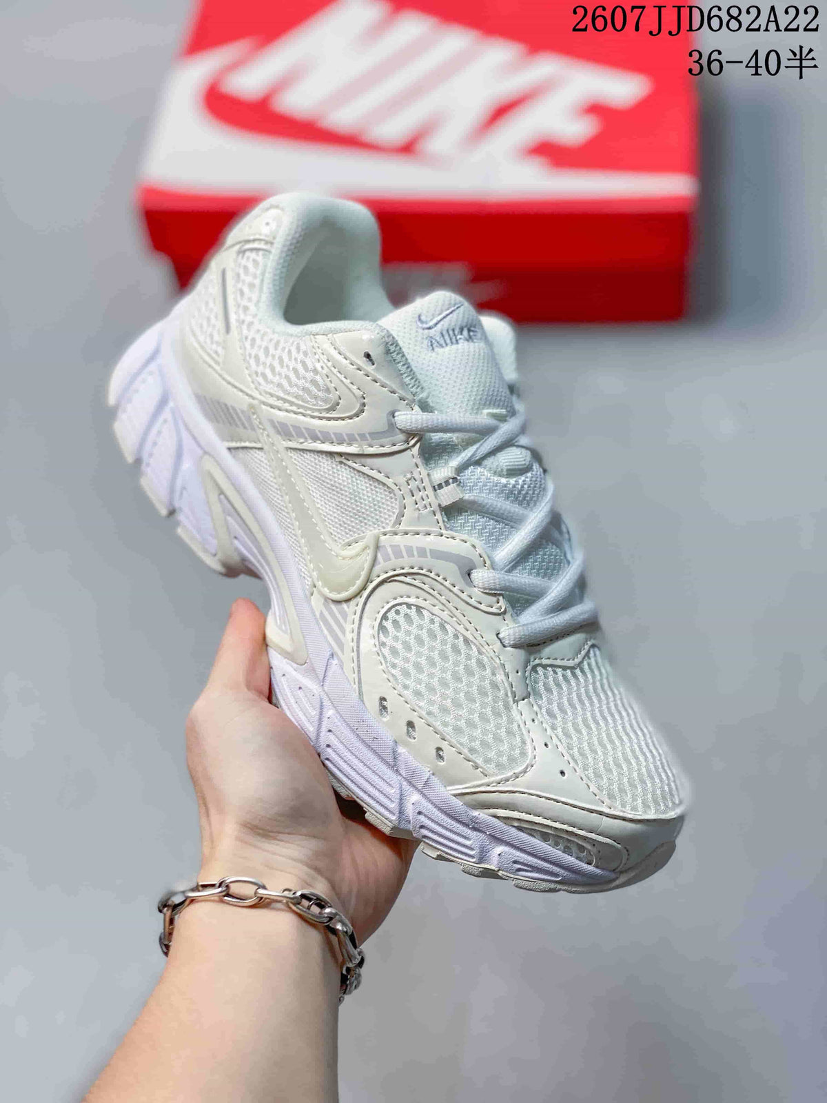 Three-quarter side view of the white Nike V5 RNR sneaker showing the mesh upper, layered side panels, laces, and thick sole.