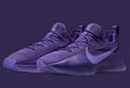 Pair of purple low-top lace-up sneakers shown against a dark purple background.