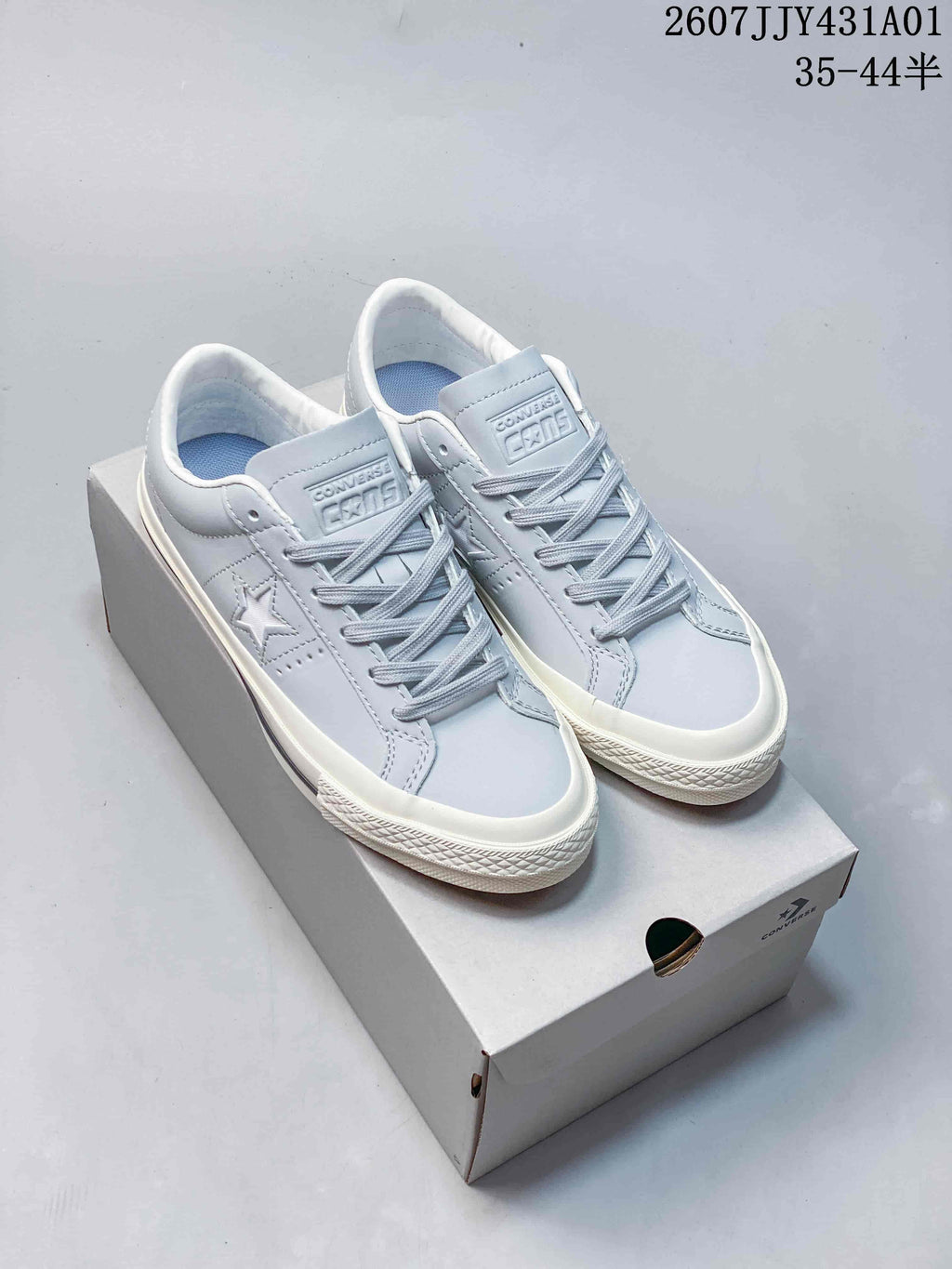 Light blue Converse One Star low-top sneakers with white sole on a shoebox